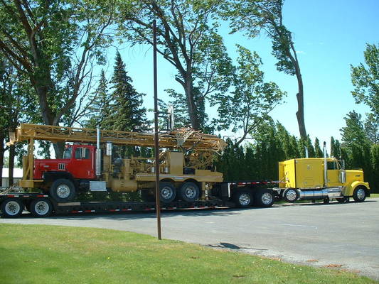 Rotary drilling rig loaded on lowboy trailer